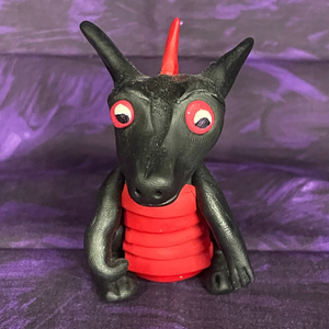 A black wingless dragon with a red stomach made of polymer clay